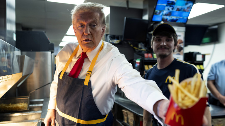 Donald Trump holding out box of McDonald's fries