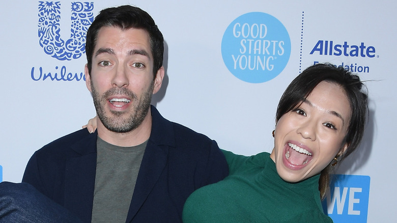 Drew Scott carries Linda Phan while making silly faces