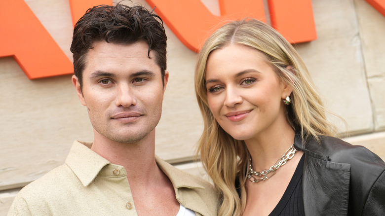 Chase Stokes and Kelsea Ballerini posing together outside