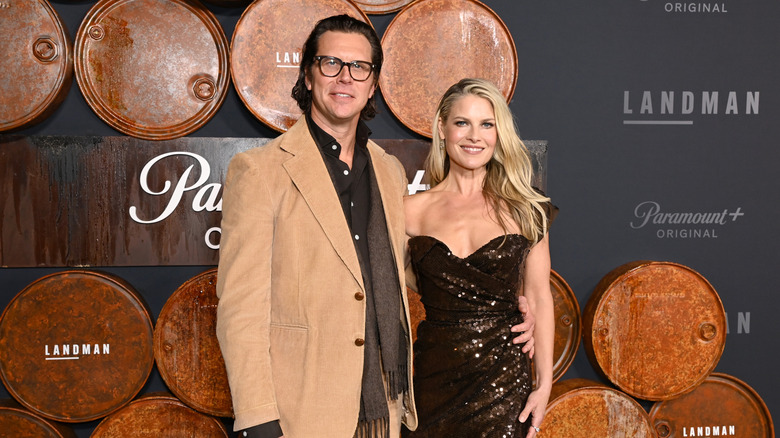 Hayes MacArthur placing his arm around Ali Larter's waist at the "Landman" premiere at Paramount Studios.