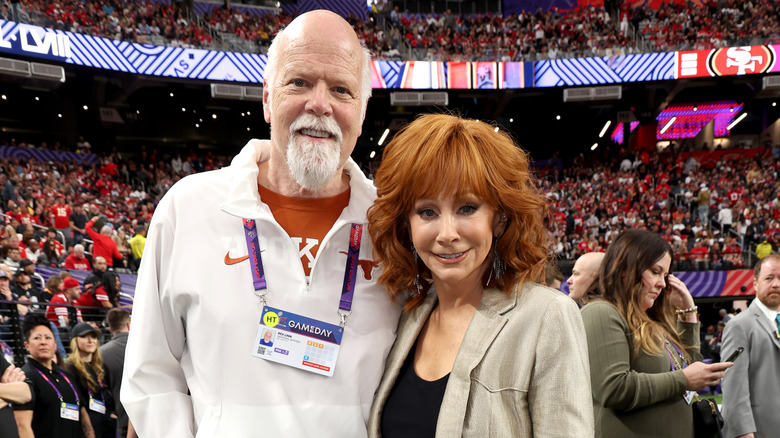 Rex Linn, Reba McEntire inside stadium