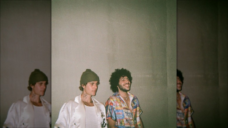 Justin Bieber and Benny Blanco stand by wall