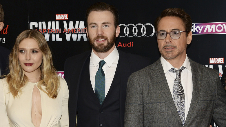 Elizabeth Olsen standing with Chris Evans