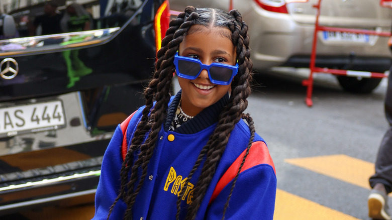 North West with blue sunglasses and braids
