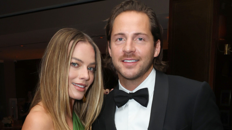 Margot Robbie and husband Tom Ackerley posing