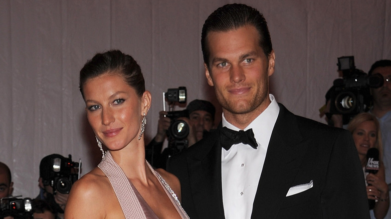 Gisele Bündchen posing on the red carpet with Tom Brady