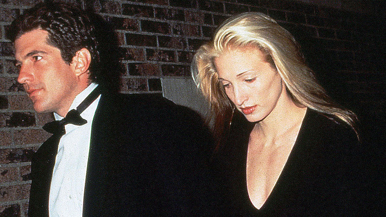 Carolyn Bessette-Kennedy gazes downward as she walks beside John F. Kennedy Jr.
