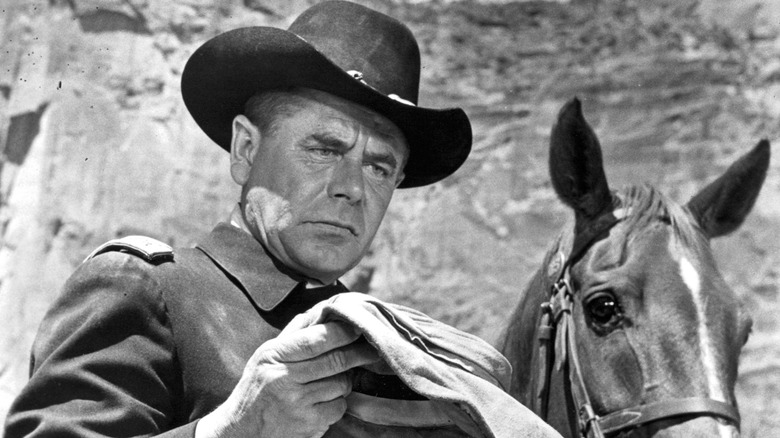 Glenn Ford next to horse in 