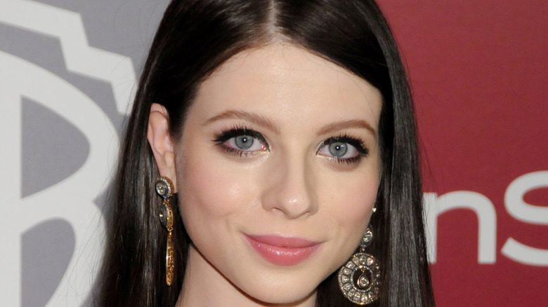 Michelle Trachtenberg wearing big earrings at an event