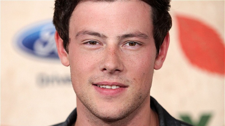 Cory Monteith smiling on a red carpet