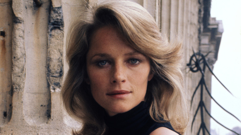 Charlotte Rampling poses outdoors in the '60s with fluffy, sideswept bangs.