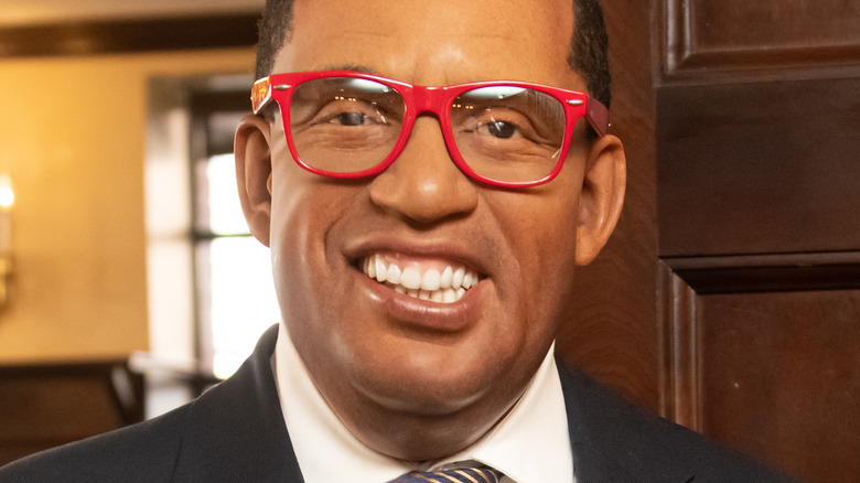 Al Roker smiling and wearing red glasses