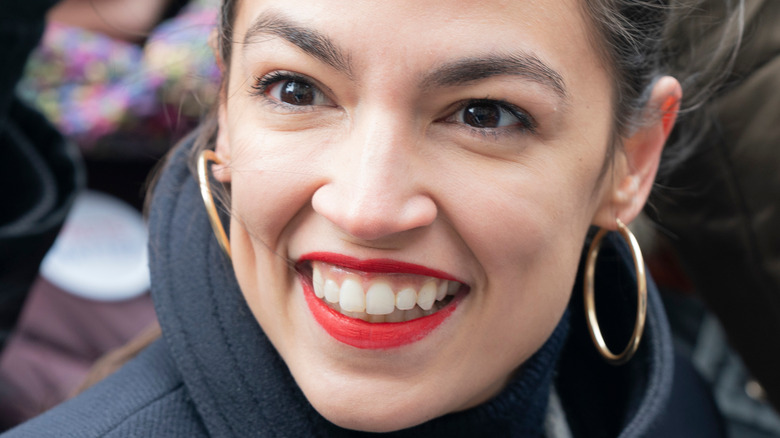 Alexandria Ocasio-Cortez outside with fans