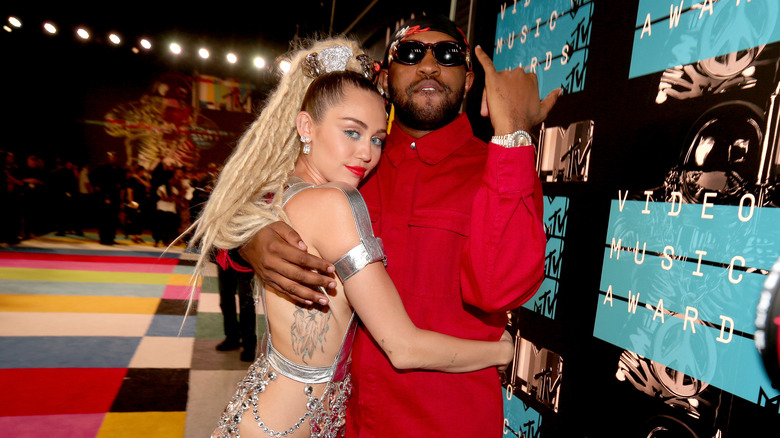 Miley Cyrus holding Mike WiLL Made-It 
