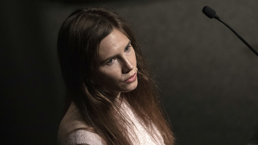 Amanda Knox at a conference podium in 2019