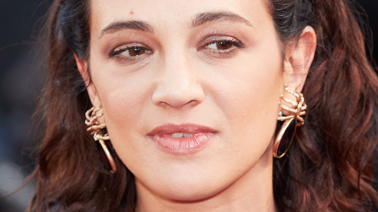 asia argento wearing gold earrings