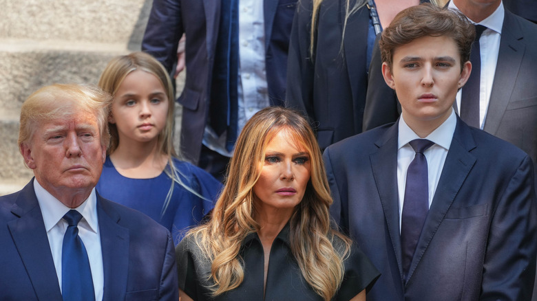 The Trump family with solemn expressions