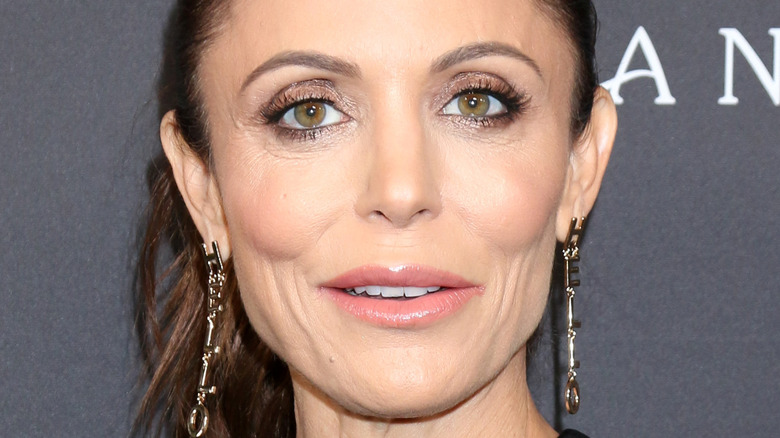 Bethenny Frankel smiling pink lip long earrings