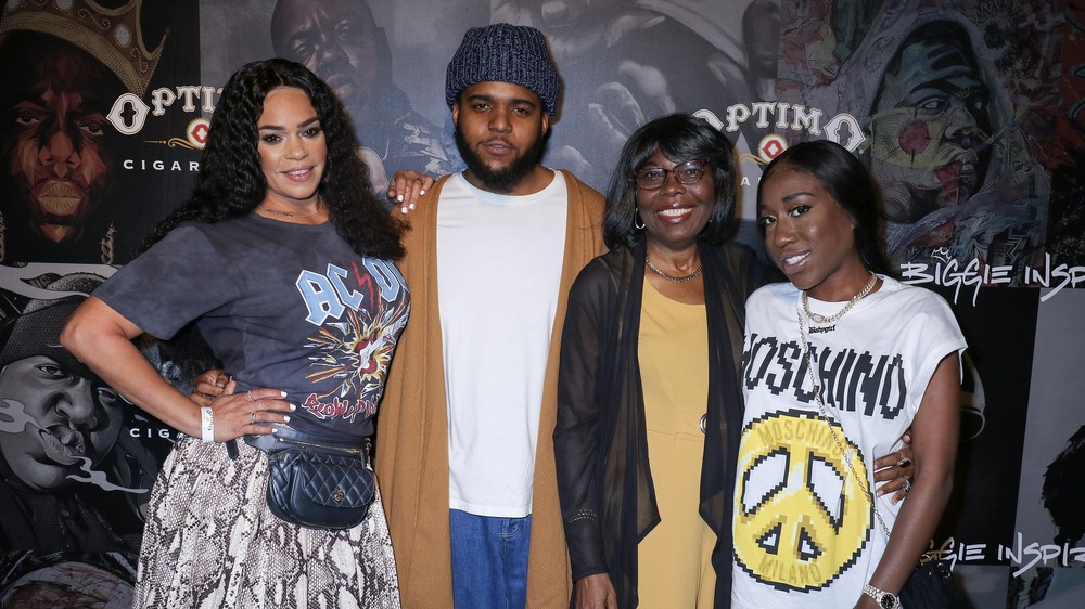 Faith Evans, CJ Wallace, T'yanna Wallace, and Voletta Wallace hugging embracing on the red carpet 