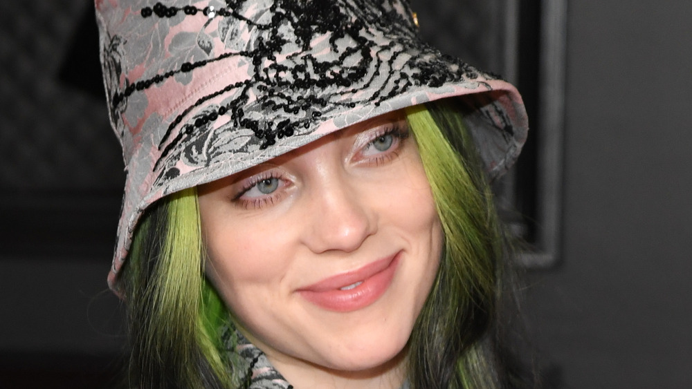 Billie Eilish poses in hat