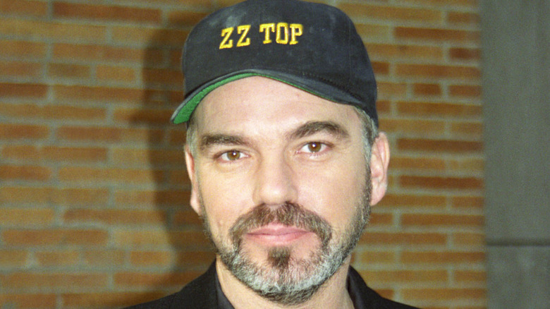 Closeup of Billy Bob Thornton posing in ZZ Top cap