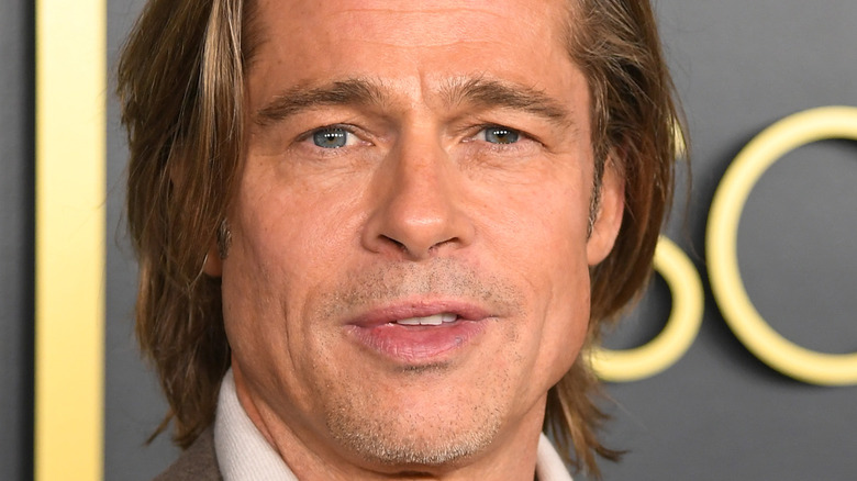 Brad Pitt posing for photo on red carpet