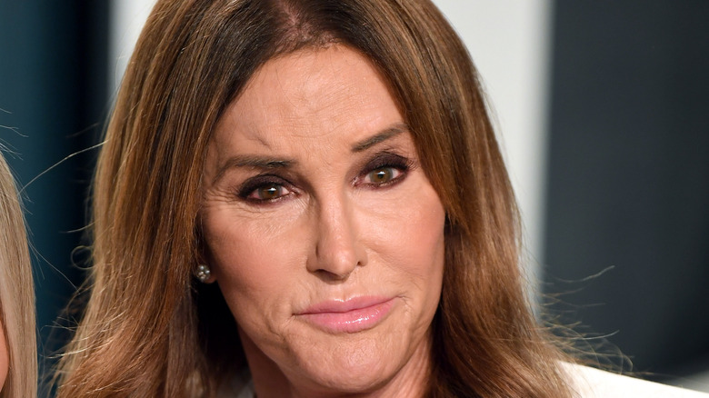 Caitlyn Jenner, looking serious, not smiling, brown hair down, 2020 red carpet, wearing white