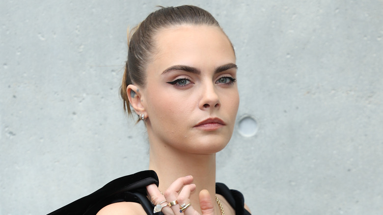 Cara Delevingne with her hair in a bun