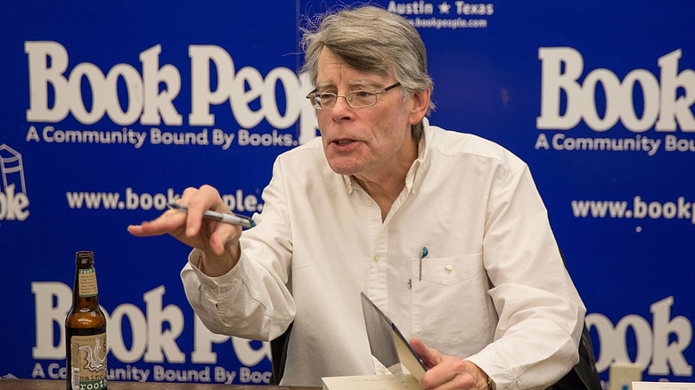 Stephen King holding pen