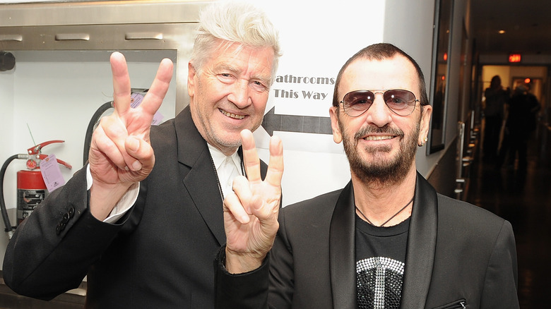 David Lynch and Ringo Starr holding the peace sign.