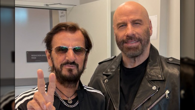 Ringo Starr posing with John Travolta backstage at a Ringo Starr and His All-Star Band concert.