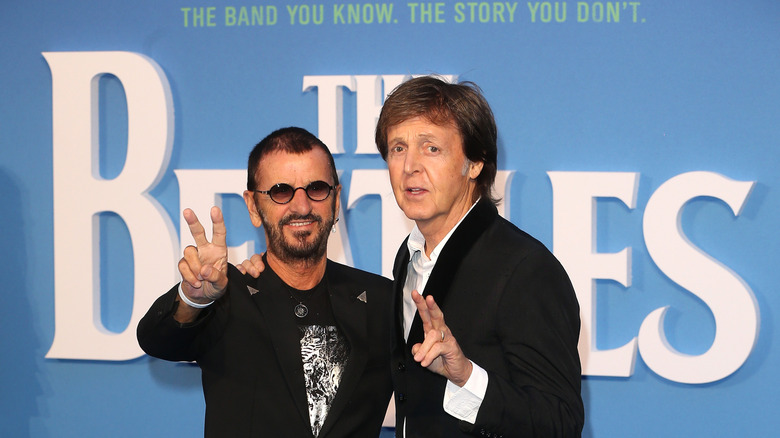 Paul McCartney and Ringo Starr posing together on the red carpet.