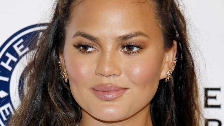 Chrissy Teigen posing at a red carpet event