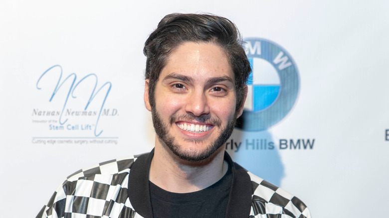 Danny Zureikat smiling in checkered jacket
