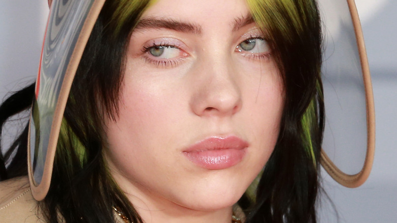 Billie Eilish on the red carpet with serious expression