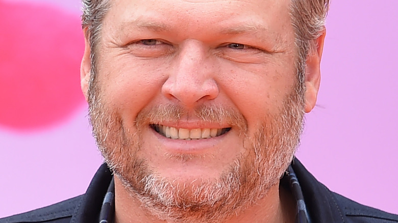 Blake Shelton smiling and looking to the side