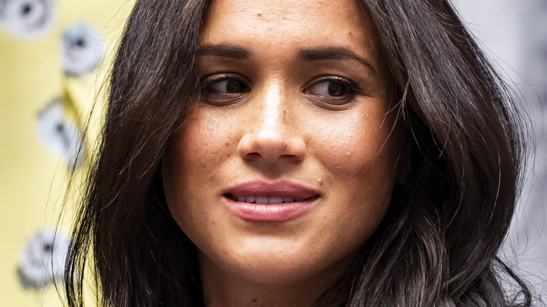 Meghan Markle with a neutral expression