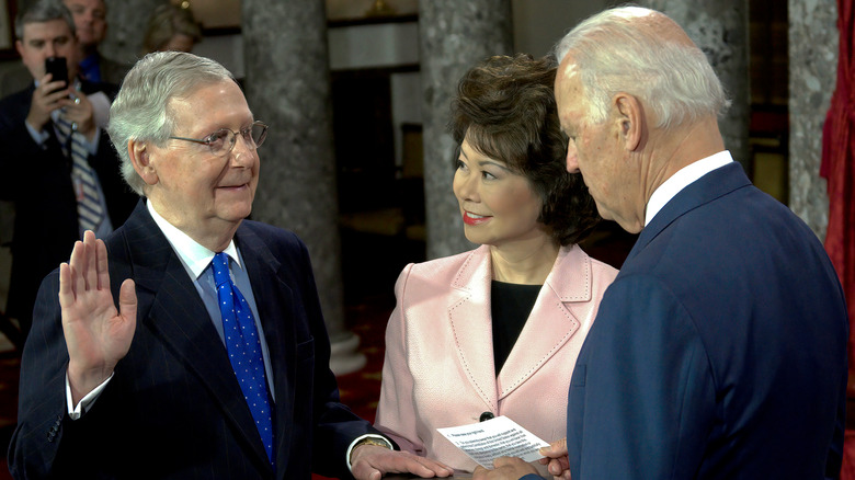 January 6, 2015 Senate Majority Leader Senator Mitch McConnell and his wife Elaine Chao holding the Bible while Vice President Joe Biden administers the oath of office