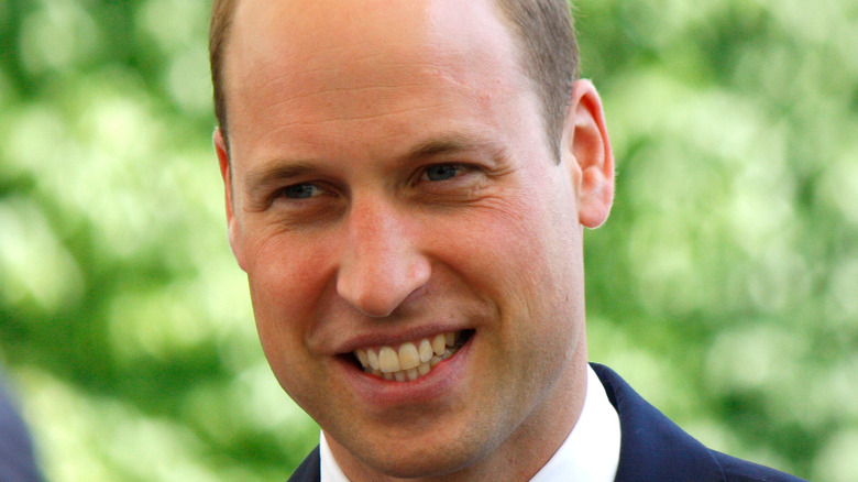 Prince William smiles at an engagement
