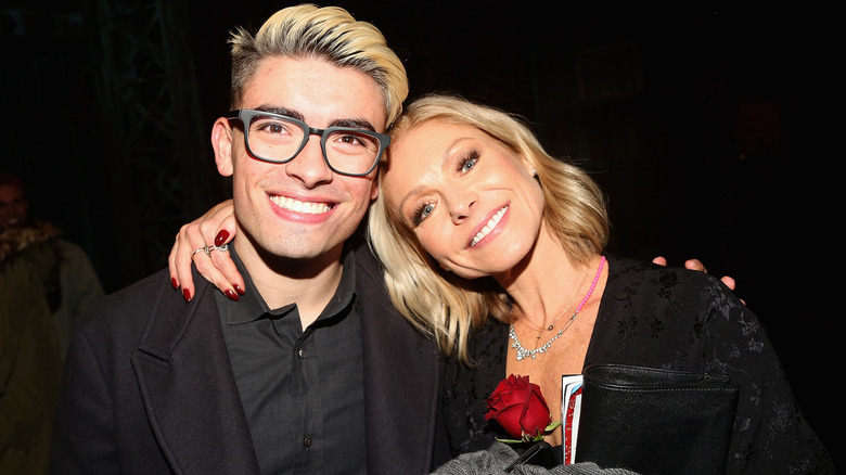 Michael Consuelos and Kelly Ripa pose for a photo