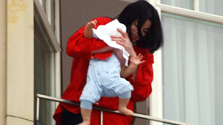 Michael Jackson dangles Prince Michael II over the balcony of the Adlon Hotel