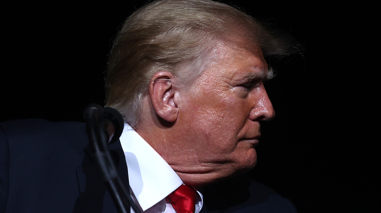 Donald Trump turned to the side on stage in 2021