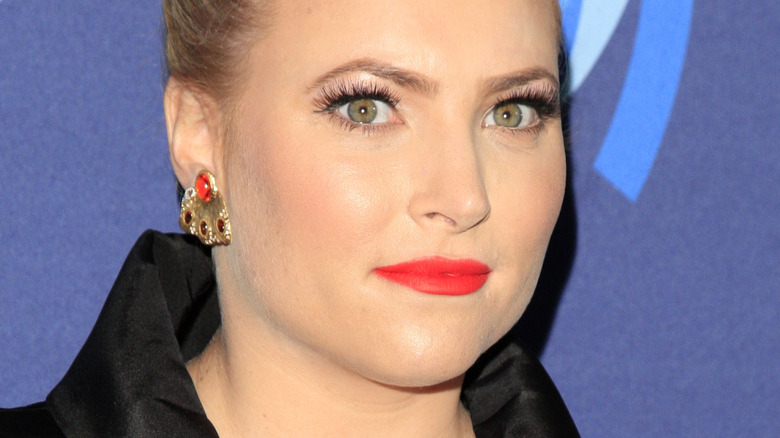 Meghan McCain with serious expression and red lipstick