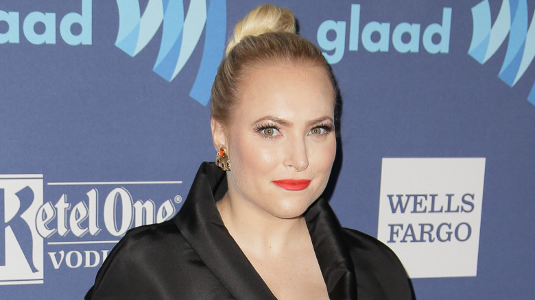 Meghan McCain with serious expression and red lipstick