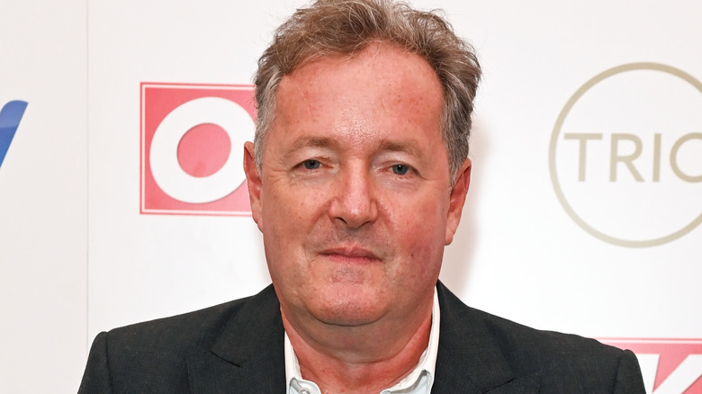 Piers Morgan smiling in close-up on red carpet
