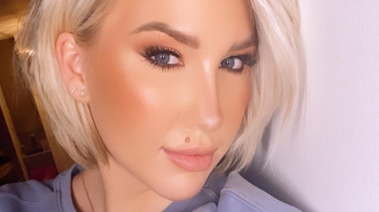 Savannah Chrisley with cross and starburst earrings