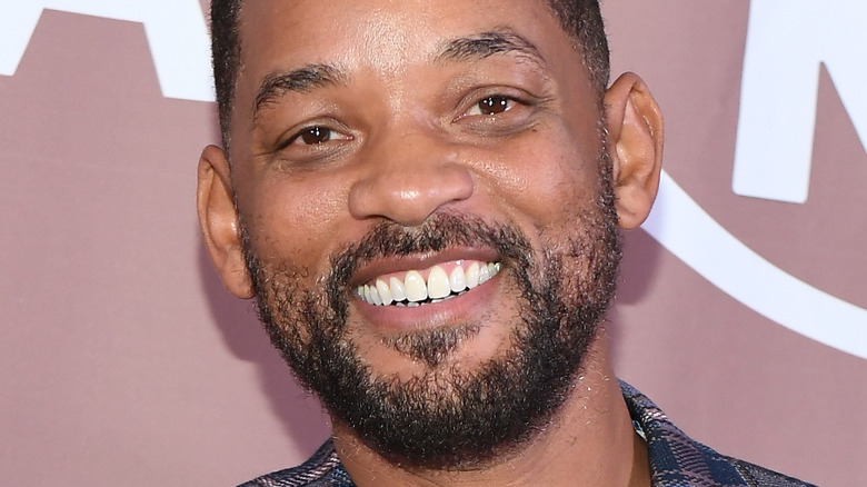Will Smith smiling on the red carpet