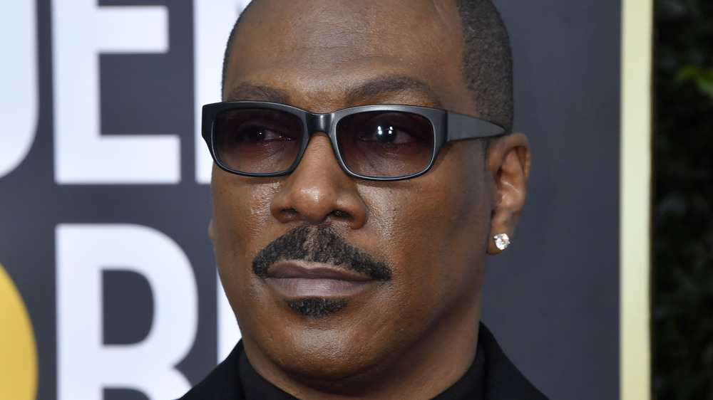 Eddie Murphy posing on the red carpet in sunglasses