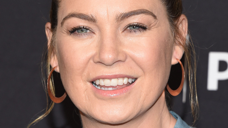 Ellen Pompeo poses in copper hoop earrings