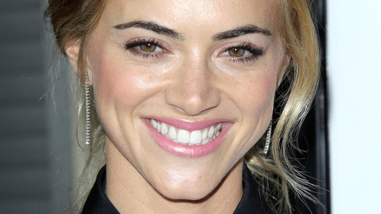 Emily Wickersham beams on the red carpet